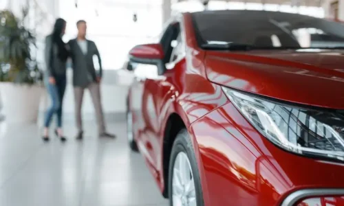 couple-buying-new-red-car-in-showroom-768x513